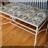F24. Metal tile top table with scenes from Shakespeare.